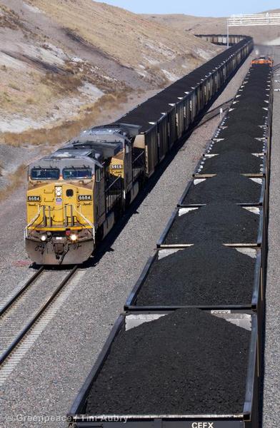Two Long Coal Trains Pass Each Other on the Rails